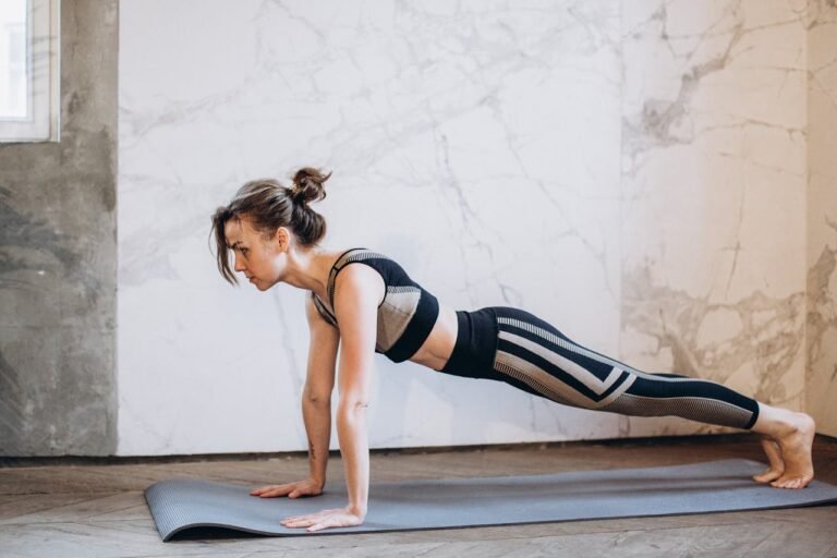 Woman in Black Tank Top and Black Leggings Doing Yoga